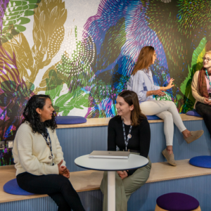 four people talking in a shared meeting space