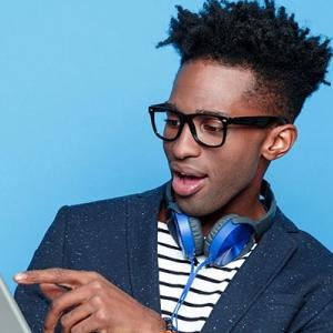 Young black make holding a tablet.