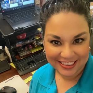 Nielsen employee shown at her computer.