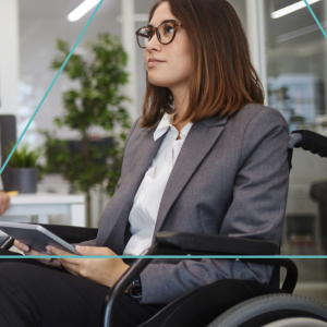 A person sitting in a wheelchair, using an electronic tablet
