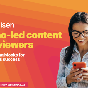 Person looking at a cell phone. On the left Nielsen logo and "Latino-led content and viewers. The building blocks for streaming's success"