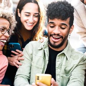Group of young people looking at their phones.