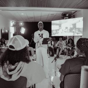 Group of people watching No Label Academy presentation