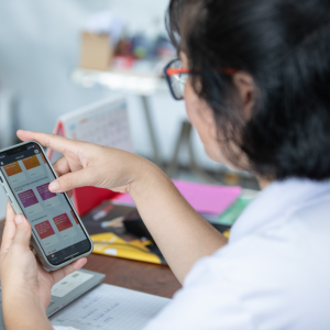 Nguyen Thi Kim Thoa in an office looking at her cellphone