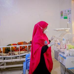 A nurse attends to Maryan and her baby.