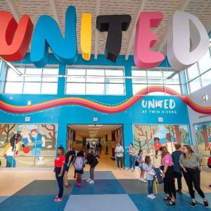 Banner of United at Twin Rivers elementary school. Students shown in the foreground.