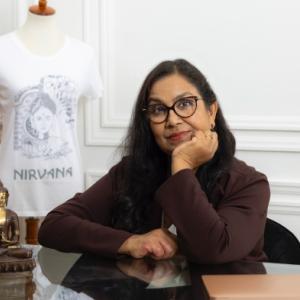 Jyoti Jaiswal sat at a table, resting their face on their hand