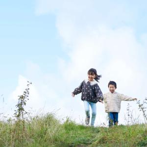 Two children running on grass
