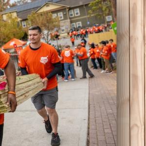 Operation Surprise! The Home Depot volunteers shown carrying lumber.