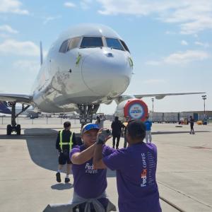 High-fives next to plane
