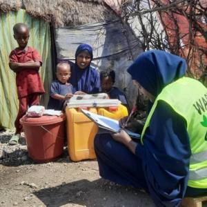 Owliya is visited by an Action Against Hunger staff member at her home after she received a water hygience kit. 