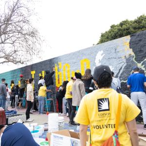Dozens of volunteers painted a mural featuring the Compton Initiative's motto "Just Do Good."