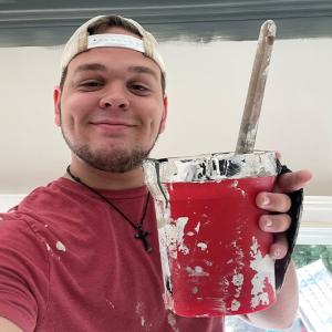 Brandon's Story: Brandon shown with a paint can.