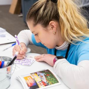 person writing cards