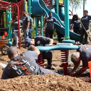 Volunteers shown assembling the playground.