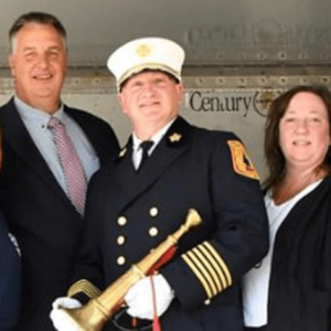 Pictured on the reviewing stand in the feature image (left to right) are Battalion Chief Scott McDermott, Councilwoman Denise Ridley, Dwyer, Fire Chief Steve McGill, Councilwoman Mira Prinz-Arey and Councilman Jermaine Robinson.