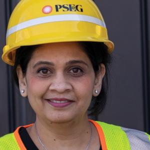 PSEG female employee wearing a hardhat and safety vest.