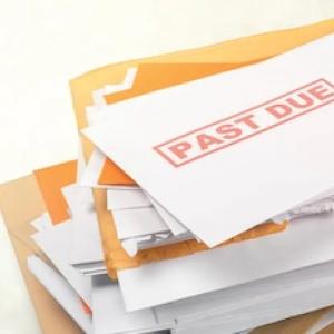 Stack of bills with past due stamped on the front.