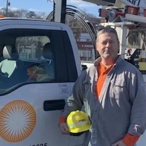 Photo of Don Brett standing in front of his PSEG truck.