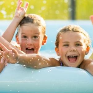 Four children in a kiddie pool.