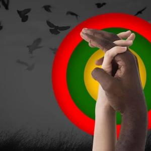 Black and white hand clasped with red, green and yellow circles behind the hands.