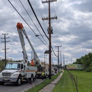 Photo showing PSEG crews updating power lines. Cherry picker truck is next to a telephone pole.