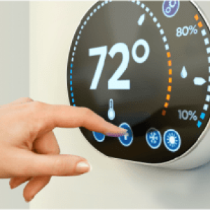 Hand setting temperature on thermostat.