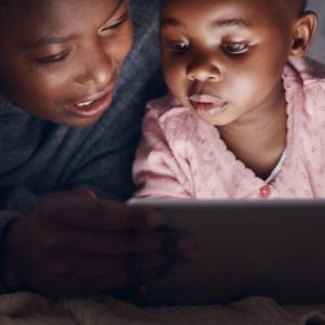Mother and daughter looking at computer screen.