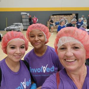 3 volunteers with hair nets