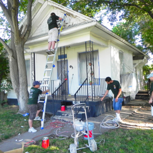 Group of people painting house