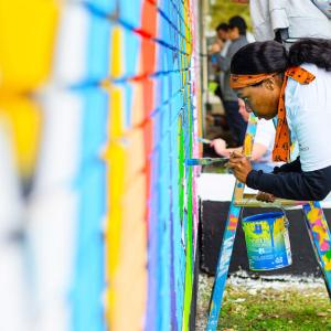 person painting a mural