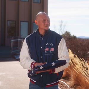 U.S. Paralympic Gold Medalist Jen Lee holding folded up American flag