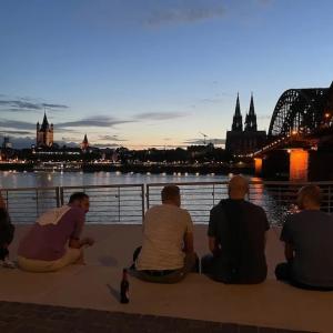 Paul seated on the bank of the Thames in London.