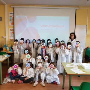 A woman stands alongside a group of children who participated in a SPARK™ lesson.