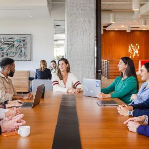 GoDaddy team members shown at a long table working.