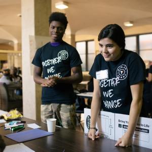 2 volunteers behind a table