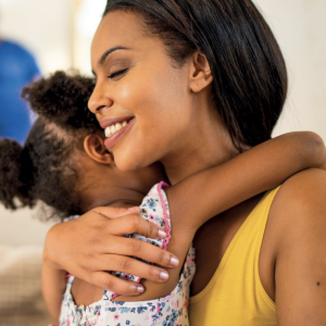 An adult and child hugging 