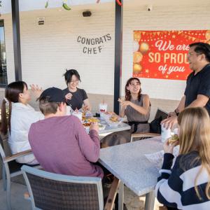 People sat around tables eating food