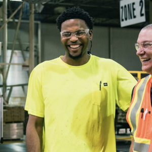Three people stood next to each other smiling