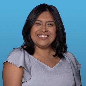 Headshot of Janet Perez against a blue background