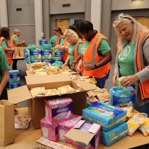 Women packaging menstrual health management supplies 