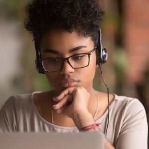 Person using a laptop wearing headphones