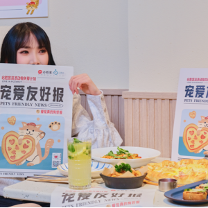 Person sat at a restaurant table holding up a newspaper