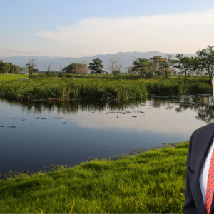 Headshot of Peter Iliopoulos against a water and trees backdrop