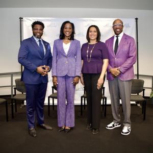 Four people standing in a conference room