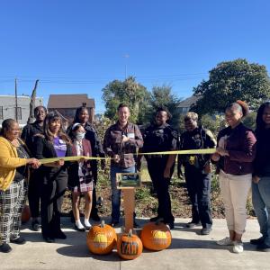 Diverse group of people cutting a ceremonial ribbon