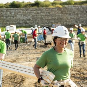 2 people carrying lumber
