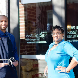 Two people stood outside a building