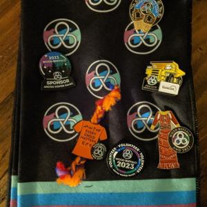 a collection of pins, including a Suncor pin