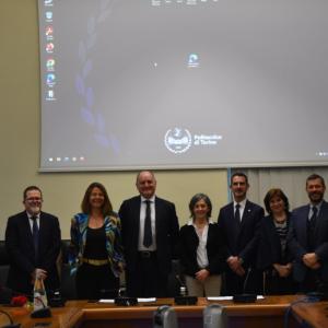A line of people stood in front of a projector board 